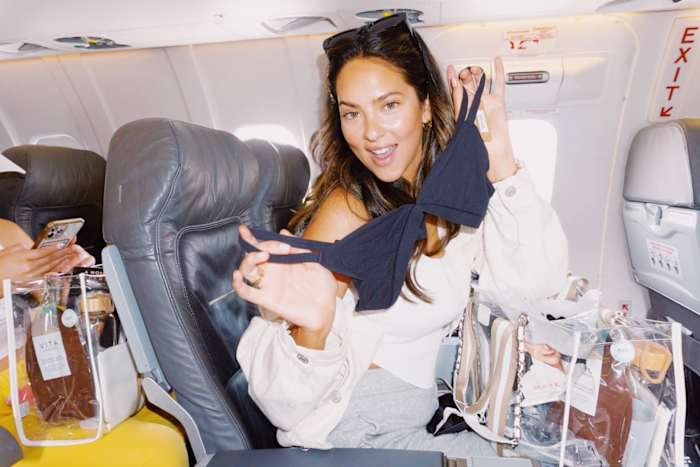 Christen Harper showing off her Skims bra from her gift bag.